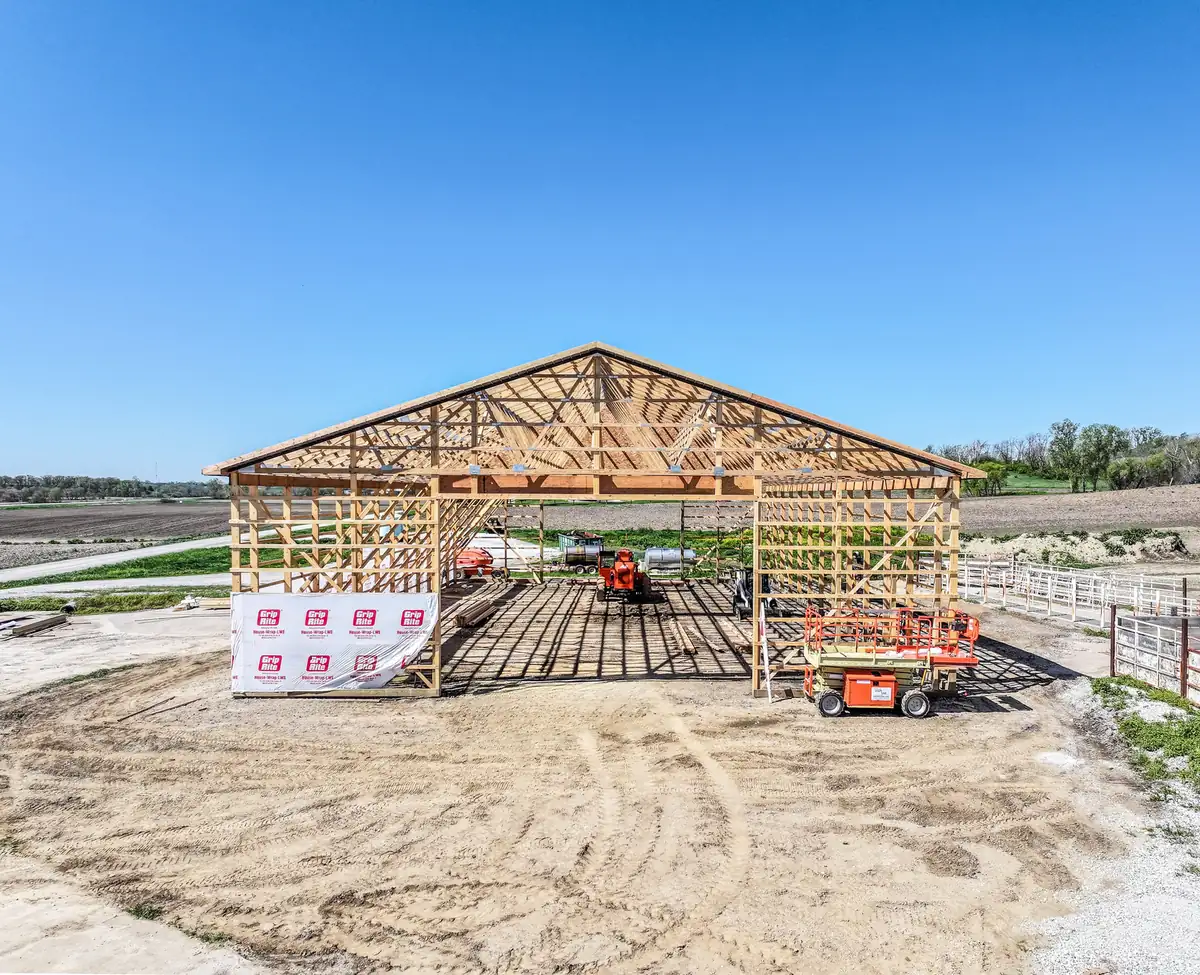 Wood trusses set on the posts of a new post frame building