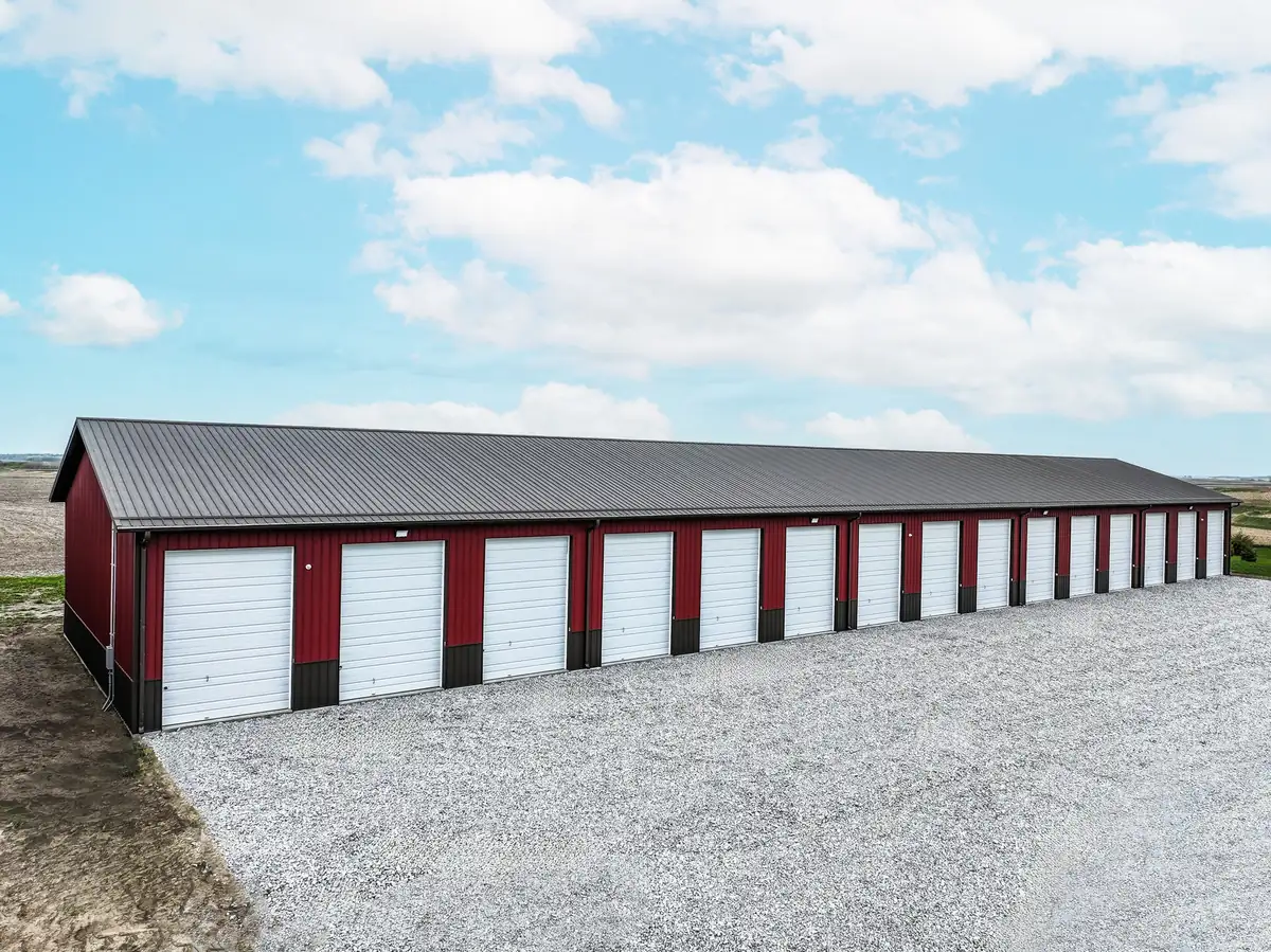 Row of self-storage units with white doors and red trim